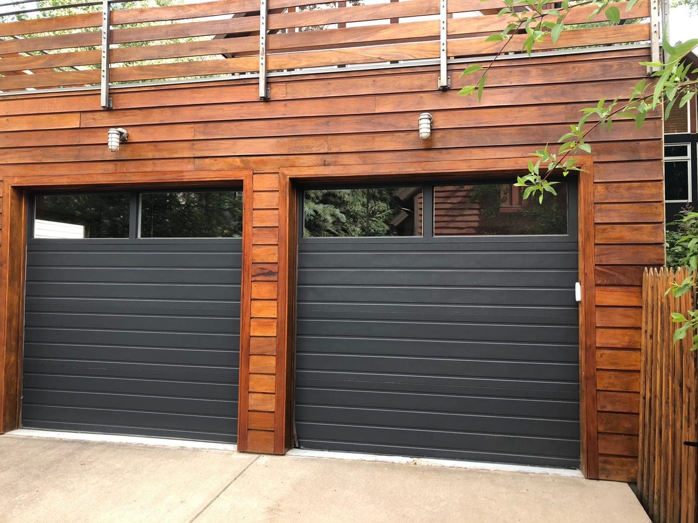 Freshly stained exterior wood siding and garage doors on an Aspen property